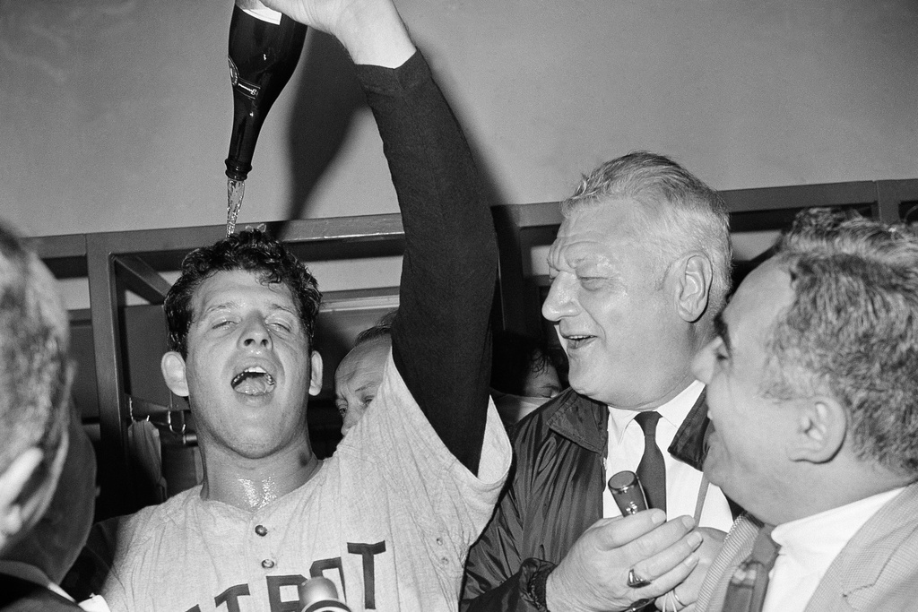 FILE- In this Oct. 10, 1968, file photo, Detroit Tigers Pitcher Mickey Lolich he pours bottle of champagne on his head in clubhouse after defeating the St. Louis Cardinals 4-1 in Game 7 of baseball's World Series in 1968. (AP Photo/File)