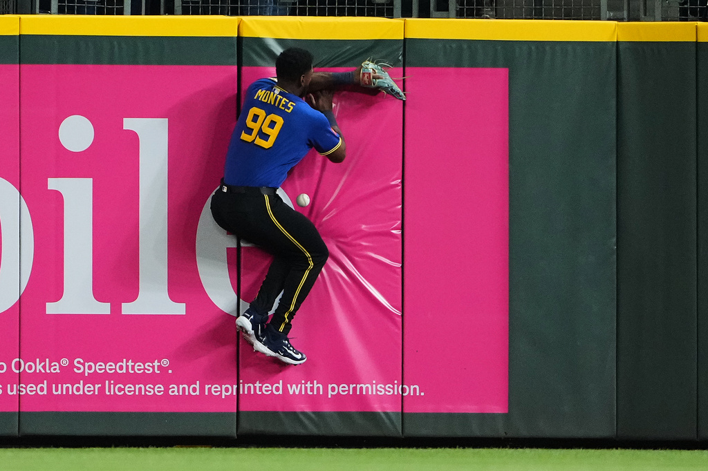 Seattle Mariners right fielder Lazaro Montes crashes into the outfield wall while trying to catch the RBI triple from Athletics' Zack Gelof during the fifth inning of a baseball game, Friday, Sept. 4, 2026, in Seattle. (AP Photo/Lindsey Wasson)
