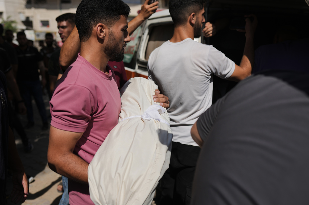 Mourners carry the body of Palestinian child Azzam Abu Al-Teif, who was killed in an Israeli airstrike alongside his father, Abdullah Abu Al-Teif, during their funeral in Gaza City, Sunday, Aug. 2, 2026. (AP Photo/Jehad Alshrafi)