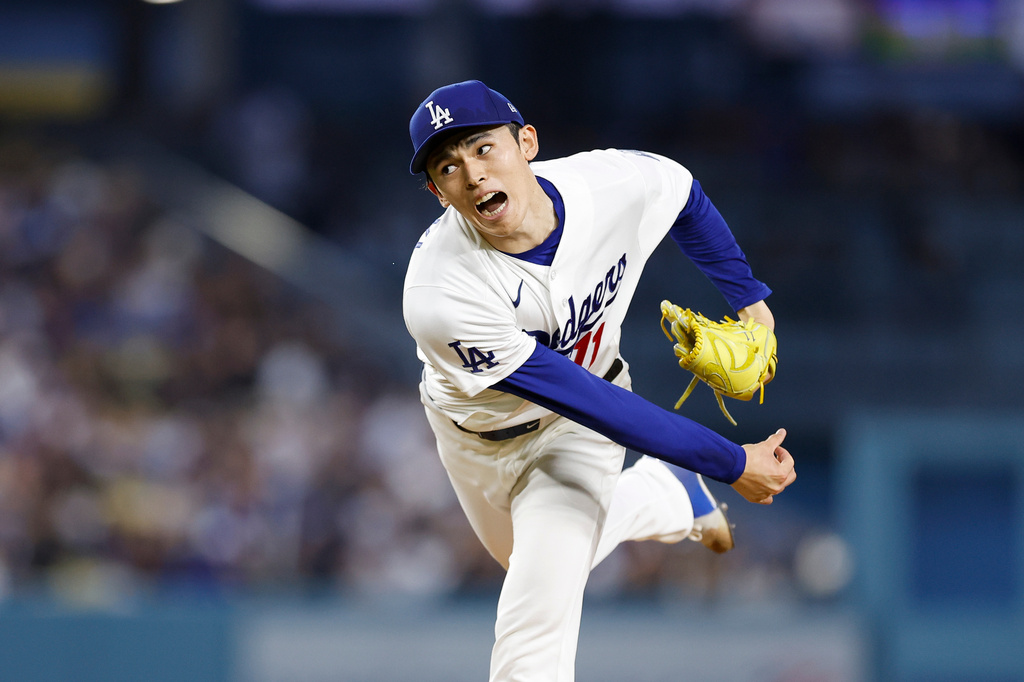 Los Angeles Dodgers starting pitcher Roki Sasaki (11) releases a pitch during the first inning of a baseball game against the Cleveland Guardians, Monday, March 30, 2026, in Los Angeles. (AP Photo/Caroline Brehman)
