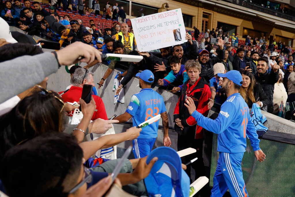 India's Virat Kohli, right, waves to supporters as he leaves the field following the one day international cricket match between Australia and India in Adelaide, Australia, Thursday, Oct. 23, 2025. (AP Photo/James Elsby)