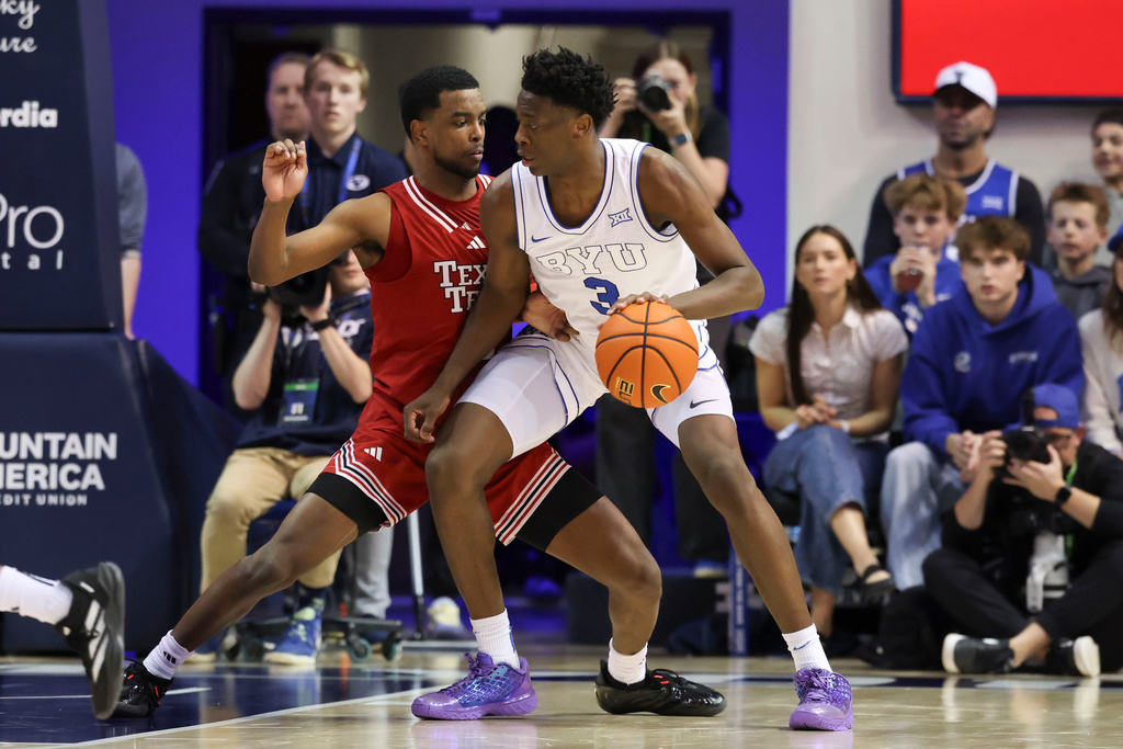 BYU guard Nate Pickens (12) posts up against Texas Tech forward Donovan Atwell, right, during the second half of an NCAA college basketball game, Saturday, March 7, 2026, in Provo, Utah. (AP Photo/Rob Gray)