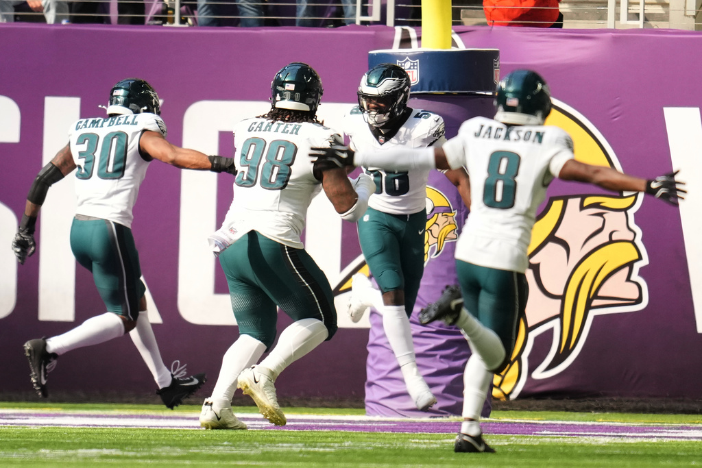 Philadelphia Eagles linebacker Jalyx Hunt (58) celebrates in the end zone after returning an interception for a touchdown during the first half of an NFL football game Sunday, Oct. 19, 2025, in Minneapolis. (AP Photo/Abbie Parr)