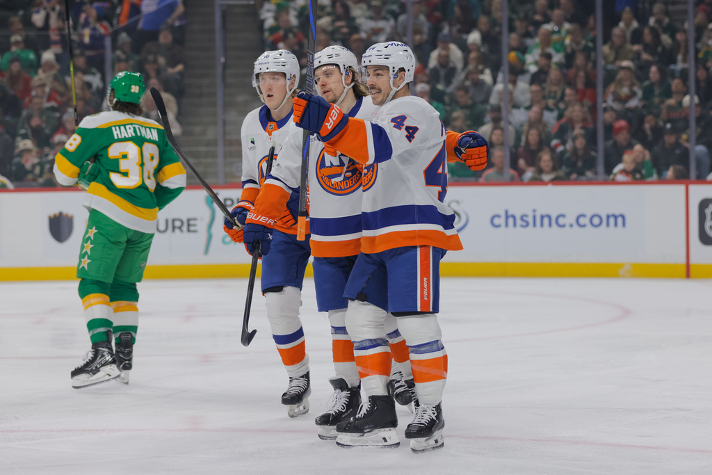 New York Islanders center Jean-Gabriel Pageau celebrates with teammates after scoring during the first period of an NHL hockey game against the Minnesota Wild, Saturday, Jan. 10, 2026, in St. Paul, Minn. (AP Photo/Bailey Hillesheim)