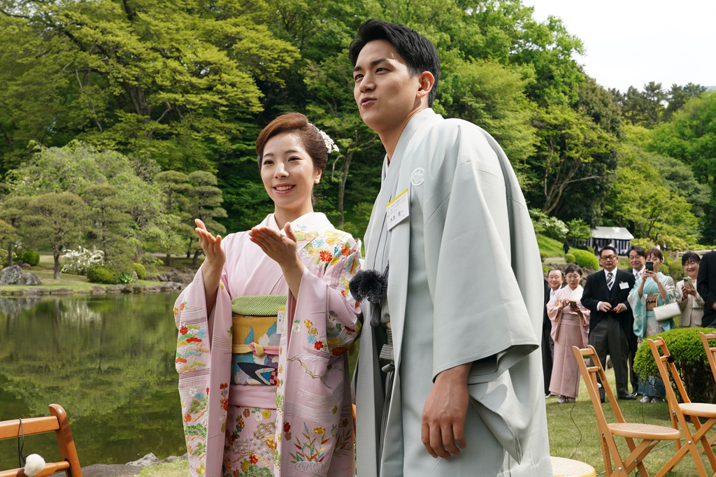 Japanese Olympic figure skating pairs champions Riku Miura, left, and Ryuichi Kihara attend a spring garden party hosted by Japan's Emperor Naruhito and Empress Masako at the Akasaka Palace's imperial garden in Tokyo, Friday, April 17, 2026. (Kazuhiro Nogi/Pool Photo via AP)
