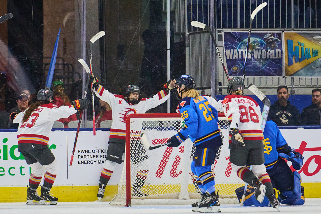 Ottawa Charge's Rebecca Leslie (second from left), celebrates with her team after scoring the game-winning goal against the Toronto Sceptres during overtime PWHL hockey action in Toronto, on Tuesday, Dec. 23, 2025. (Sammy Kogan/The Canadian Press via AP)