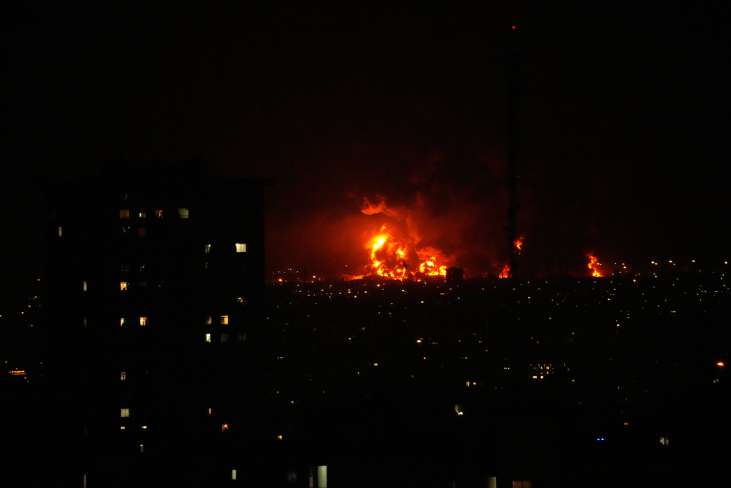 Flames rise from an oil storage facility south of the capital Tehran as strikes hit the city during the U.S.–Israel military campaign, Iran, Saturday, March 7, 2026. (AP Photo/Vahid Salemi)