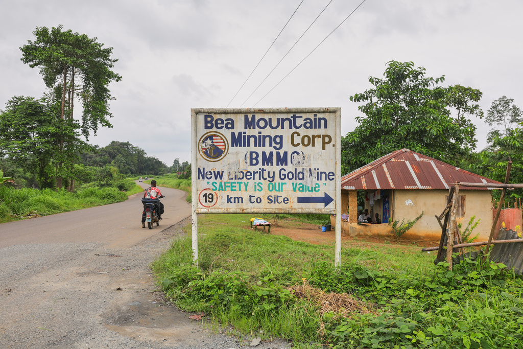 A sign gives directions to the New Liberty Gold Mine, operated by Bea Mountain Mining Corporation, in Grand Cape Mount County, Liberia, July 7, 2025. (AP Photo/Misper Apawu)