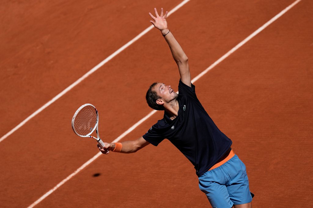 The tennis ball casts a shadow on the court, left, as Daniil Medvedev of Russia serves to Adam Walton of Australia during their first round men's singles tennis match at the French Open tennis tournament in Paris, Tuesday, May 26, 2026. (AP Photo/Christophe Ena)