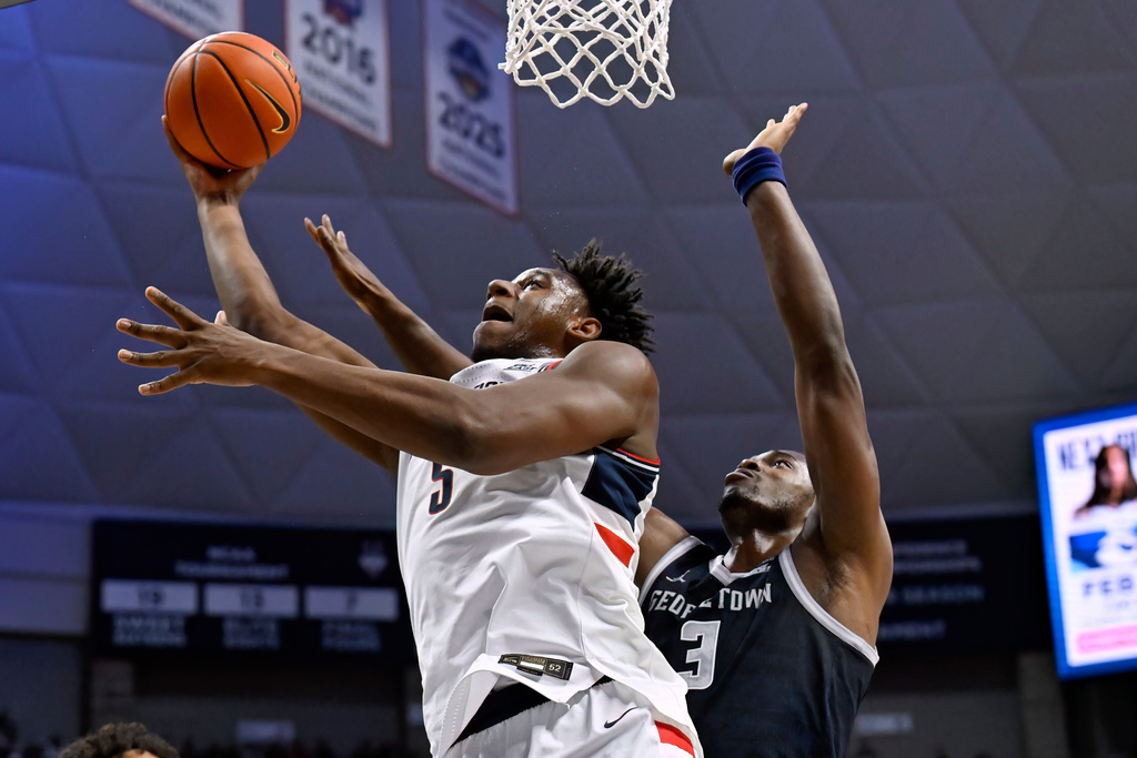 UConn forward Tarris Reed Jr. (5) shoots as Georgetown center Vincent Iwuchukwu (3) defends in the first half of an NCAA college basketball game, Saturday, Feb. 14, 2026, in Storrs, Conn. (AP Photo/Jessica Hill)