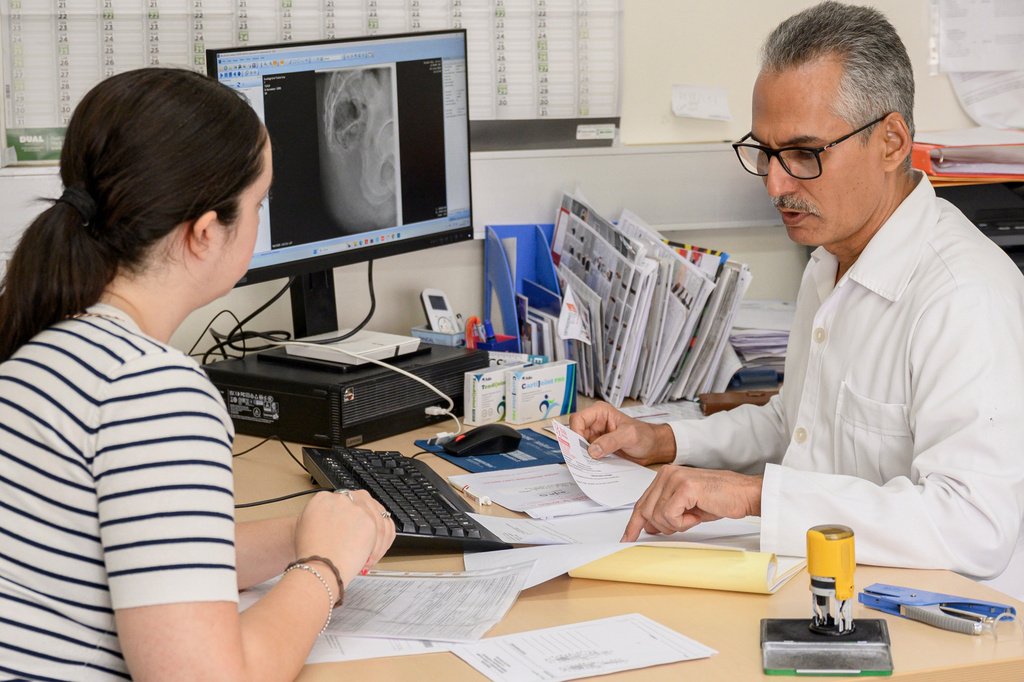 Cuban doctor Raciel Escalona Zaldivar, right, talks to a patient in an orthopedic unit of the Santa Maria degli Ungheresi Hospital of Polistena in the southern Italian Calabria region, June 16, 2026. (AP Photo/Valeria Ferraro)
