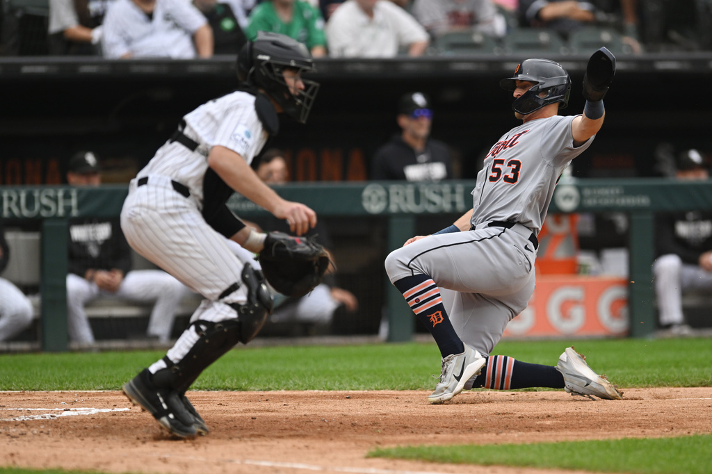 Detroit Tigers' Ben Malgeri (53) slides safely into home plate on a Kevin McGonigle sacrifice fly as Chicago White Sox catcher Kyle Teel, left, waits for the throw during the fifth inning of a baseball game Saturday, Sept. 19, 2026, in Chicago. (AP Photo/Paul Beaty)