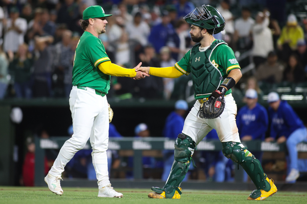Athletics pitcher Mark Leiter Jr., left, and catcher Shea Langeliers celebrate the Athletics win over the Kansas City Royals in a baseball game Wednesday, April 29, 2026, in West Sacramento, Calif. (AP Photo/Scott Marshall)