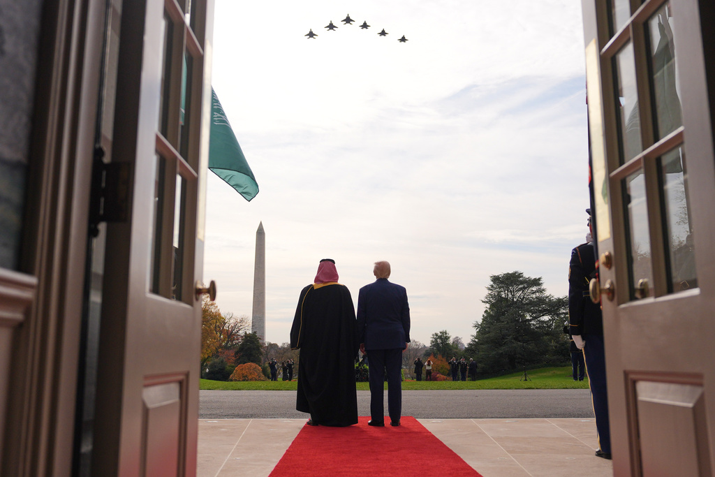 President Donald Trump and Saudi Arabia's Crown Prince Mohammed bin Salman watch a flight of F-35's and F-15's fly over during a welcome ceremony on the South Lawn of the White House, Tuesday, Nov. 18, 2025, in Washington. (AP Photo/Evan Vucci)