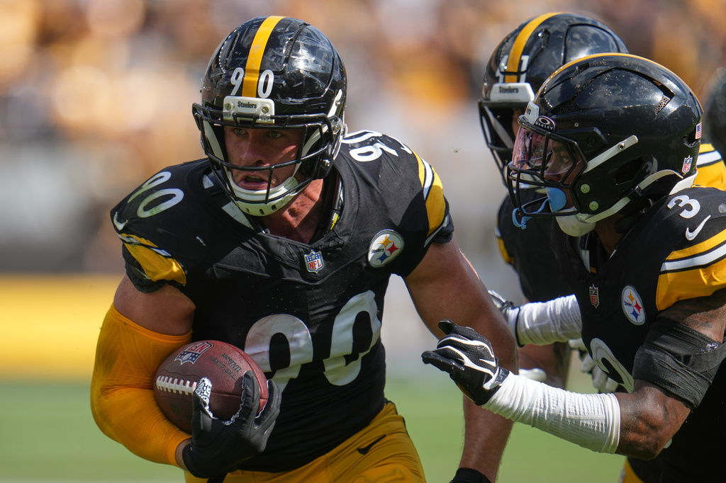 Pittsburgh Steelers outside linebacker T.J. Watt (90) returns an interception in for a touchdown during an NFL football game, Sunday, Sept. 13, 2026, in Pittsburgh. (AP Photo/Gene J. Puskar)