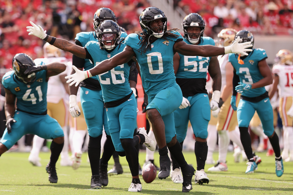 Jacksonville Jaguars linebacker Devin Lloyd (0) celebrates with teammates after intercepting a pass against the San Francisco 49ers during the second half of an NFL football game in Santa Clara, Calif., Sunday, Sept. 28, 2025. (AP Photo/Kelley L. Cox)