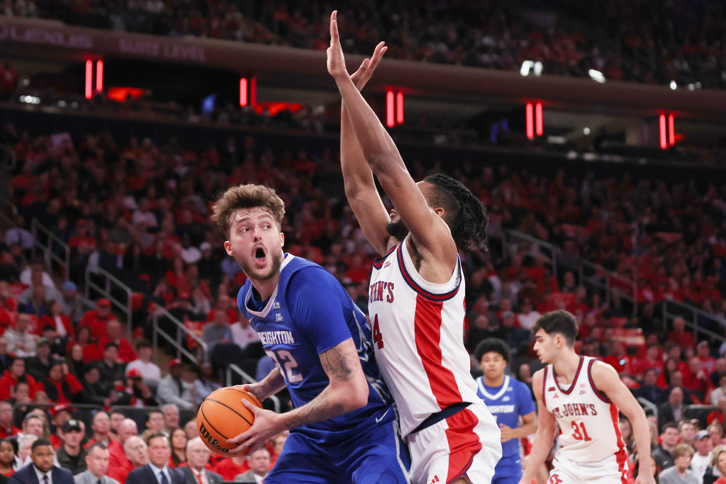 Creighton forward Owen Freeman (32) looks for an outlet as St. John's forward Zuby Ejiofor defends during the first half of an NCAA college basketball game, Saturday, Feb. 21, 2026, in New York. (AP Photo/Heather Khalifa)