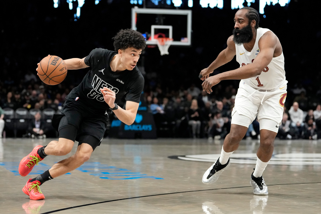Brooklyn Nets guard Nolan Traore, left, drives past Cleveland Cavaliers guard James Harden (1) during the first half of an NBA basketball game, Sunday, March 1, 2026, in New York. (AP Photo/Yuki Iwamura)
