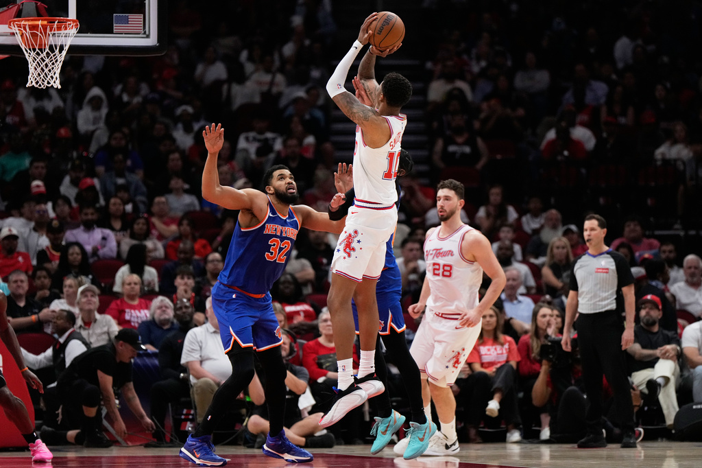 Houston Rockets forward Jabari Smith Jr. (10) shoots against New York Knicks center Karl-Anthony Towns (32) during the first half of an NBA basketball game in Houston, Tuesday, March 31, 2026. (AP Photo/Ashley Landis)
