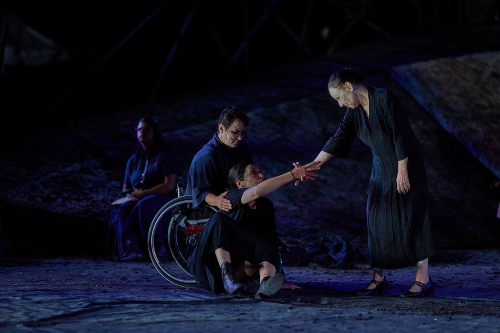 From left to right, Eirini Kourouvani, a wheelchair dancer, Evi Saoulidou and Lydia Fotopoulou perform during a dress rehearsal of Euripides' tragedy The Trojan Women, staged by the National Theatre of Greece, at the Ancient Theater of Epidaurus, Greece, on Thursday, July 30, 2026. (AP Photo/Petros Giannakouris)