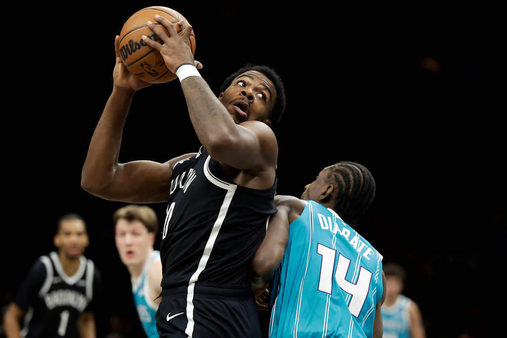 Brooklyn Nets center Day'Ron Sharpe, left, drives past Charlotte Hornets forward Moussa Diabate (14) during the first half of an NBA basketball game Monday, Dec. 1, 2025, in New York. (AP Photo/Adam Hunger)