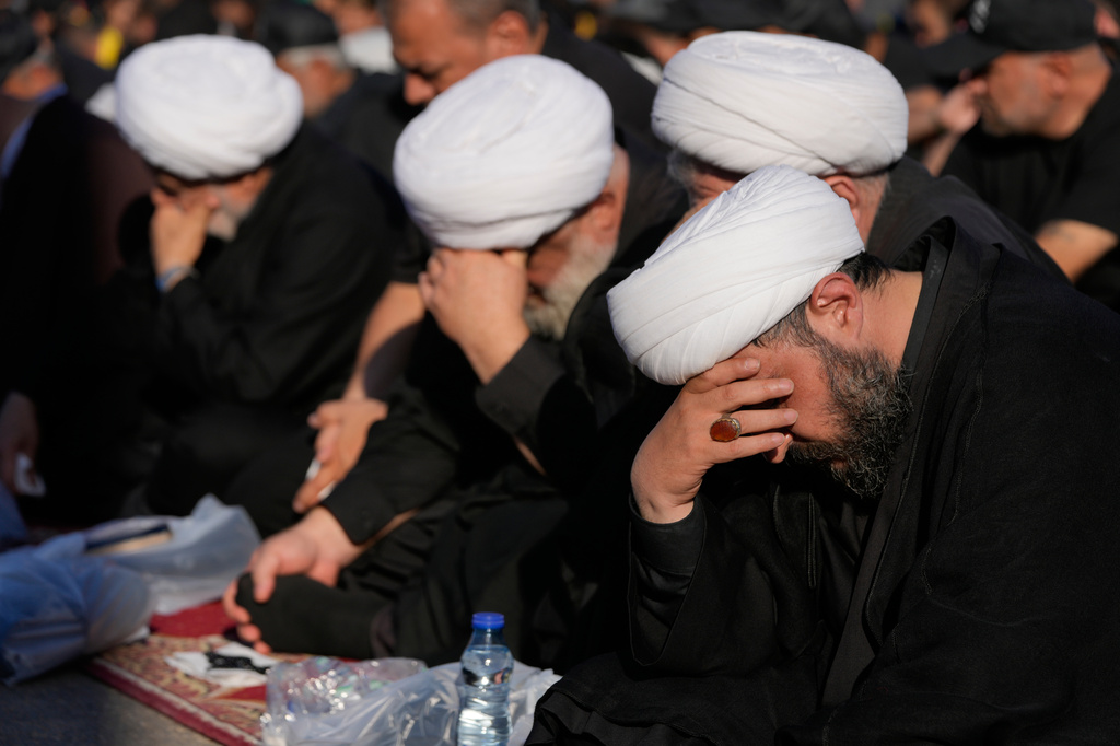 Hezbollah cleric mourn as they listen to the death story of Imam Hussein during the holy day of Ashoura that commemorates the 7th century martyrdom of the Prophet Muhammad's grandson Hussein, in Dahiyeh, Beirut's southern suburbs, Lebanon, Friday, June 26, 2026. (AP Photo/Hussein Malla)