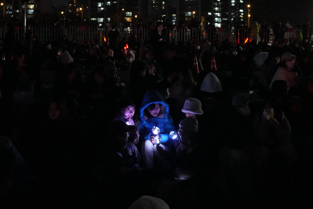 Japanese fans of K-pop band BTS before a drone light show to celebrate the comeback of the K-pop band BTS at a park along the Han River in Seoul, South Korea, Friday, March 20, 2026. (AP Photo/Lee Jin-man)
