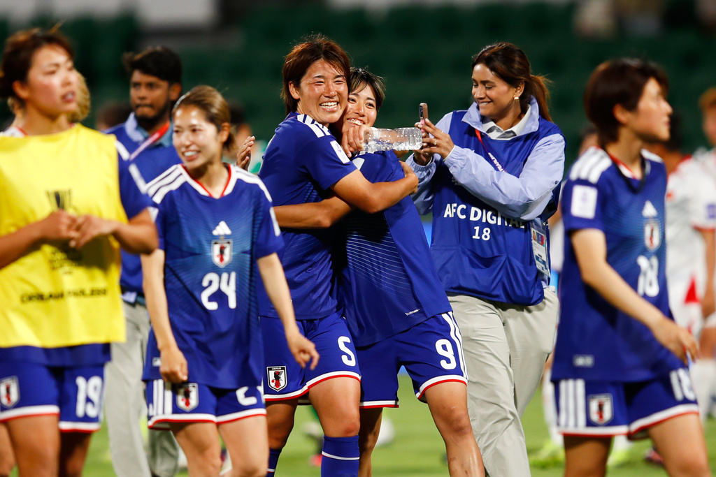Japan's Hana Takahashi and Japan's Riko Ueki embrace as they leave the field following the Women's Asian Cup soccer match between Japan and Vietnam in Perth, Australia, Tuesday, March 10, 2026. (AP Photo/Gary Day)