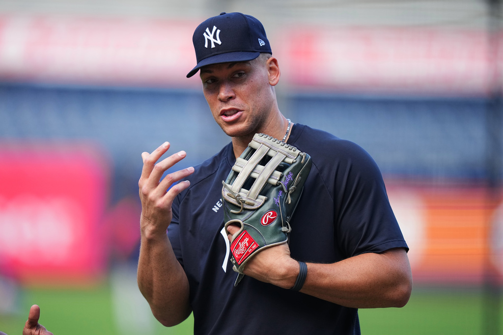 New York Yankees' Aaron Judge talks to third base/outfield coach Luis Rojas before a baseball game against the Houston Astros Tuesday, Aug. 25, 2026, in New York. (AP Photo/Frank Franklin II)