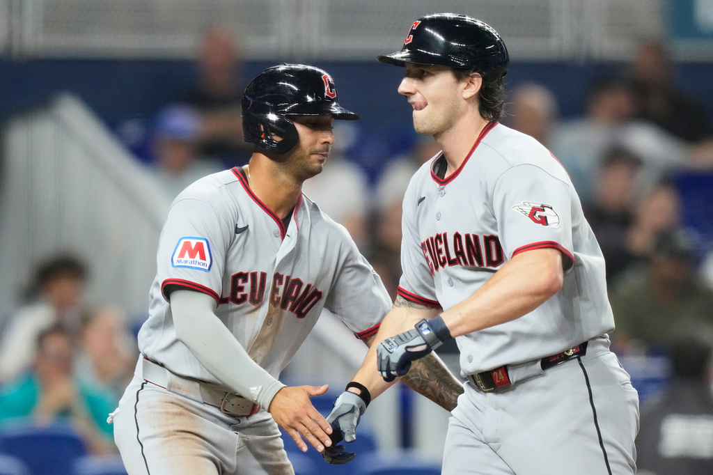Cleveland Guardians' Chase DeLauter, right, is met at the plate after hitting a two run home run during the fourth inning of a baseball game against the Miami Marlins, Friday, July 10, 2026, in Miami. (AP Photo/Lynne Sladky)
