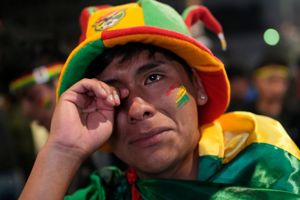 FILE - A Bolivian fans wipes away tears after his country's team loss to Iraq in a World Cup qualifying playoff final soccer match, in La Paz, Bolivia, April 1, 2026. (AP Photo/Juan Karita, File)