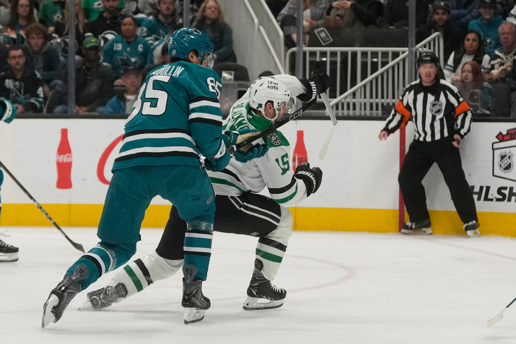 San Jose Sharks defenseman Shakir Mukhamadullin, left, is called for a penalty against Dallas Stars center Colin Blackwell (15) during the second period of an NHL hockey game in San Jose, Calif., Thursday, Dec. 18, 2025. (AP Photo/Jeff Chiu)