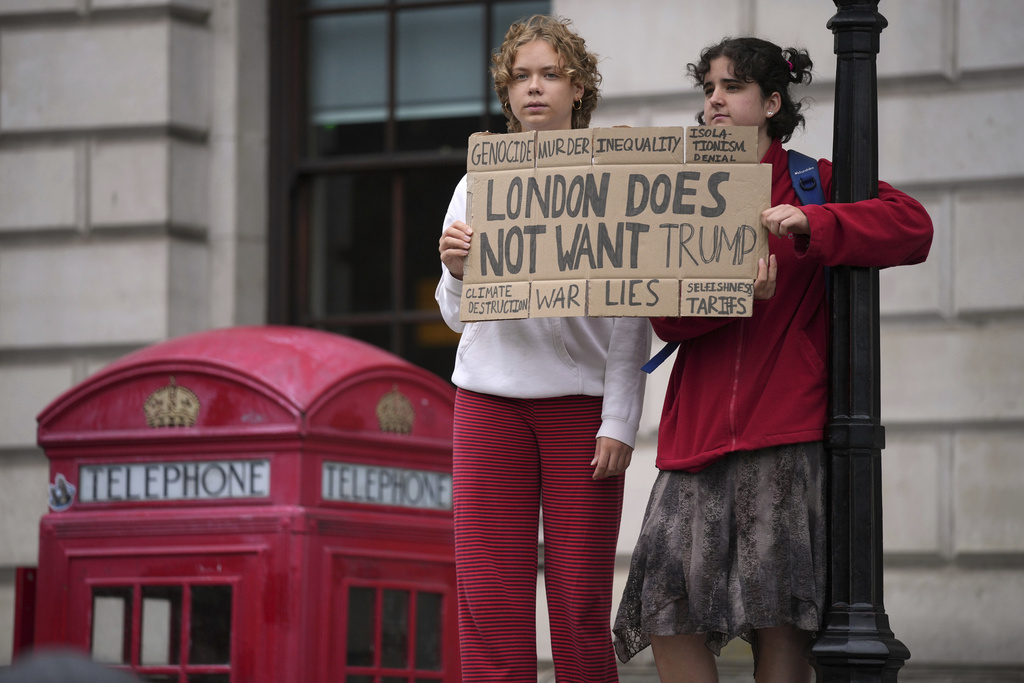 Protesters hold a placard during a demonstration of the Stop Trump Coalition group against President Donald Trump's state visit in London, Wednesday, Sept. 17, 2025.(AP Photo/Kin Cheung)