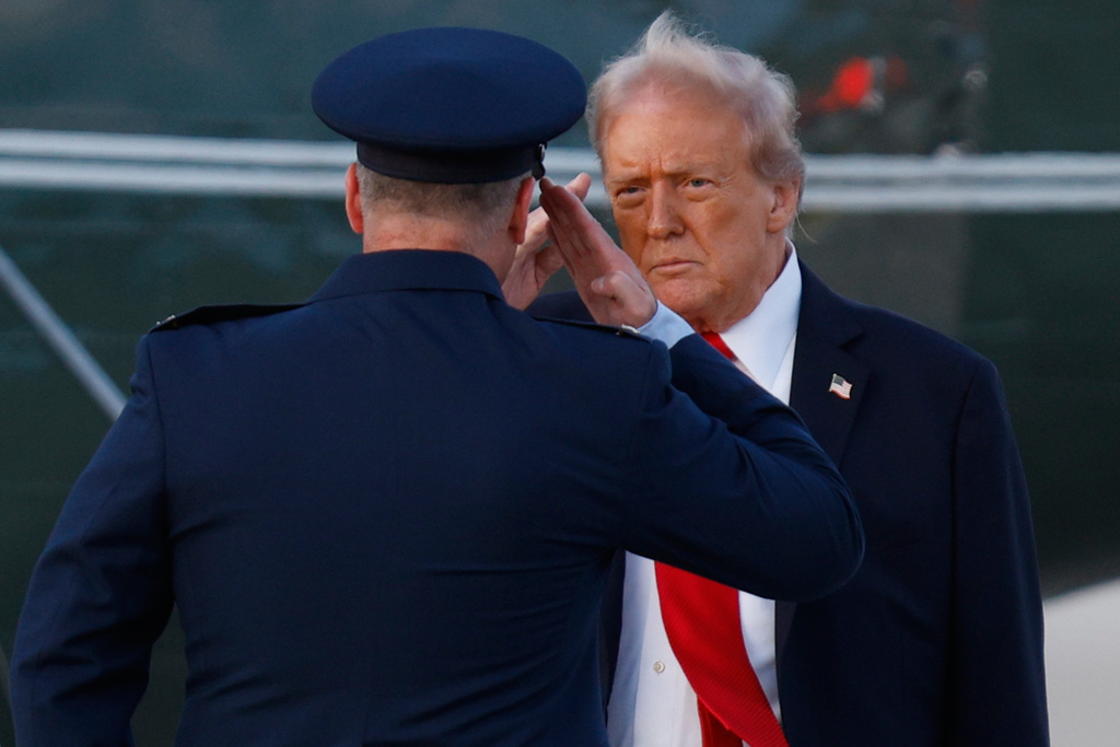 President Donald Trump, right, salutes Air Force Col. Christopher M. Robinson, Commander, 89th Airlift Wing, left, before boarding Marine One upon his arrival at Joint Base Andrews, Md., Sunday, Sept. 7, 2025. (AP Photo/Luis M. Alvarez)