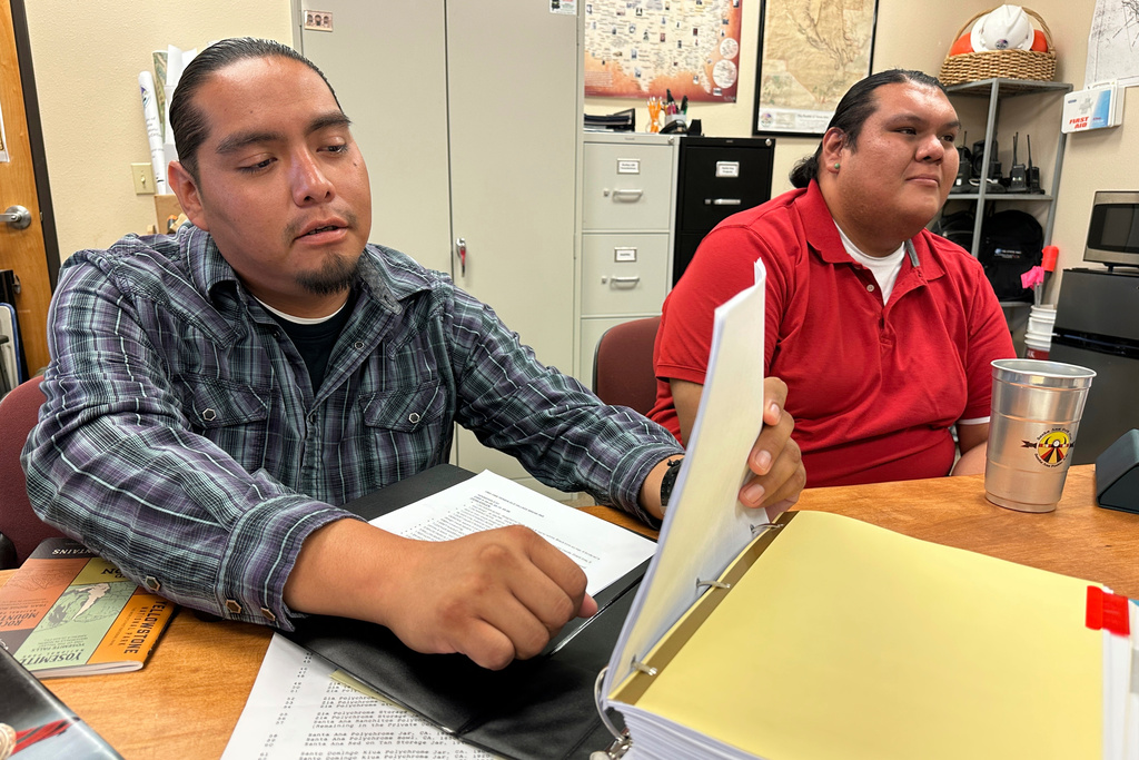 Cultural resources coordinator Jarrett Lujan with Santa Ana Pueblo's Tribal Historic Preservation Department, left, and colleague Thomas Armijo talk about a cold case involving the theft of sacred and culturally significant items decades ago during an interview in Santa Ana Pueblo, N.M., on June 26, 2025. (AP Photo/Susan Montoya Bryan)