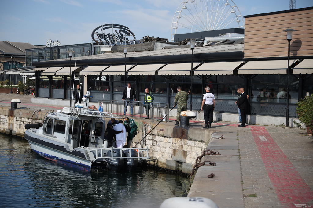 Bulgarian authorities take an injured crew member to a hospital after two commercial vessels were attacked in the NATO member's Black Sea economic zone on Tuesday, Oct. 6, 2026, Varna, in what was the first such attack on shipping in the area. (Bulgarian News Agency via AP)
