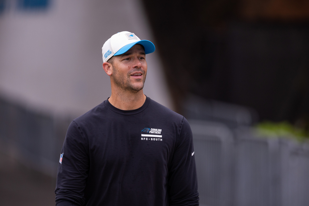 Carolina Panthers head coach Dave Canales walks up to the field forc} the NFL football team's training camp Friday, July 24, 2026, in Charlotte, N.C. (AP Photo/Scott Kinser)