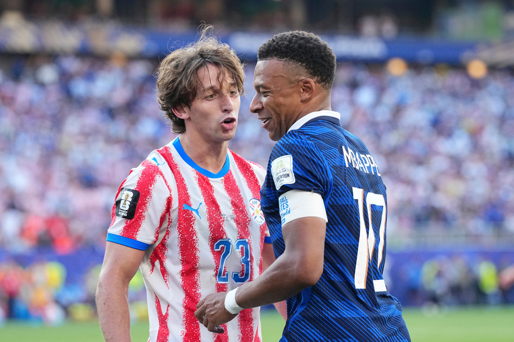 Paraguay's Matias Galarza (23) talks with France's Kylian Mbappe (10) during the World Cup round of 16 soccer match between Paraguay and France in Philadelphia, Saturday, July 4, 2026. (AP Photo/Martin Meissner)