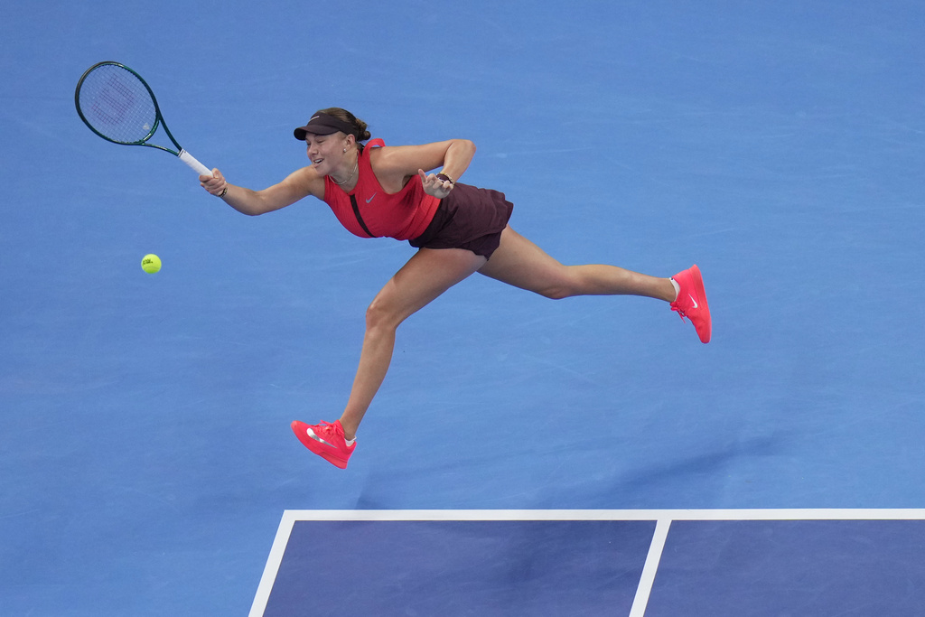 Amanda Anisimova, of the United States returns a forehand shot from Linda Noskova, of the Czech Republic during the women's singles final match of the China Open tennis tournament, at the National Tennis Center, in Beijing, Sunday, Oct. 5, 2025. (AP Photo/Andy Wong)