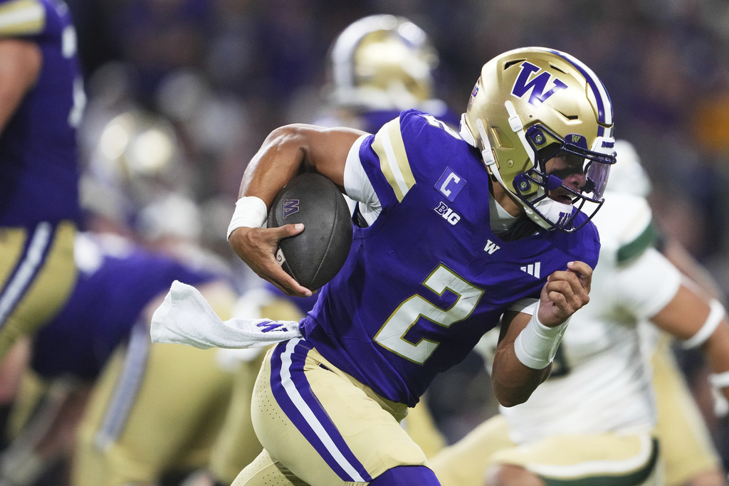 Washington quarterback Demond Williams Jr. runs the ball against Colorado State during the first half of an NCAA college football game Saturday, Aug. 30, 2025, in Seattle. (AP Photo/Lindsey Wasson)