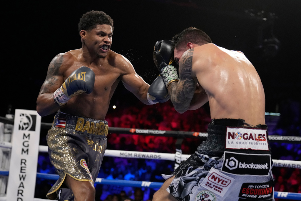 FILE - Shakur Stevenson, left, throws a punch at Oscar Valdez during the WBC-WBO junior lightweight title boxing bout Saturday, April 30, 2022, in Las Vegas. (AP Photo/John Locher, file)