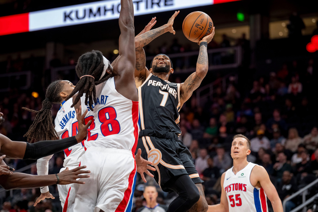 Atlanta Hawks guard Nickeil Alexander-Walker (7) attempts a basket against Detroit Pistons forward/center Isaiah Stewart (28) during the first half of an NBA basketball game, Tuesday, Nov. 18, 2025, in Atlanta. (AP Photo/Erik Rank)