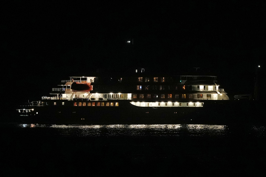 A night view of the MV Hondius cruise ship anchored at a port in Praia, Cape Verde, Tuesday, May 5, 2026. (AP Photo/Misper Apawu)