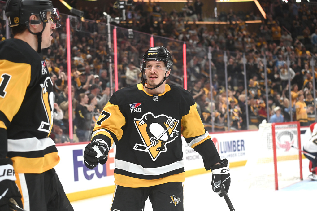 Pittsburgh Penguins center Evgenii Malkin (71) is congratulated by right wing Rickard Rakell (67) after scoring his second goal of the game against the Florida Panthers during the second period of an NHL game, Saturday, April 4, 2026, in Pittsburgh. (AP Photo/Philip G. Pavely)