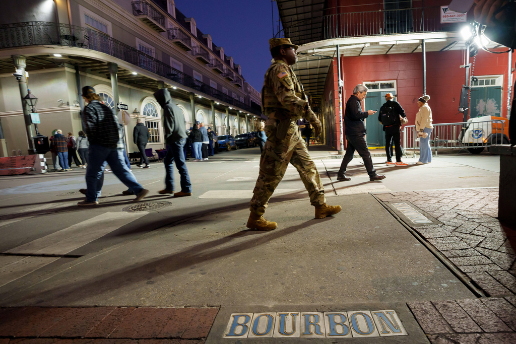 The Louisiana National Guard, military police, and Louisiana law enforcement agencies patrol the French Quarter along Bourbon Street and intersecting streets as part of a National Guard deployment for New Year's celebrations in New Orleans, Tuesday, Dec. 30, 2025. (AP Photo/Matthew Hinton)