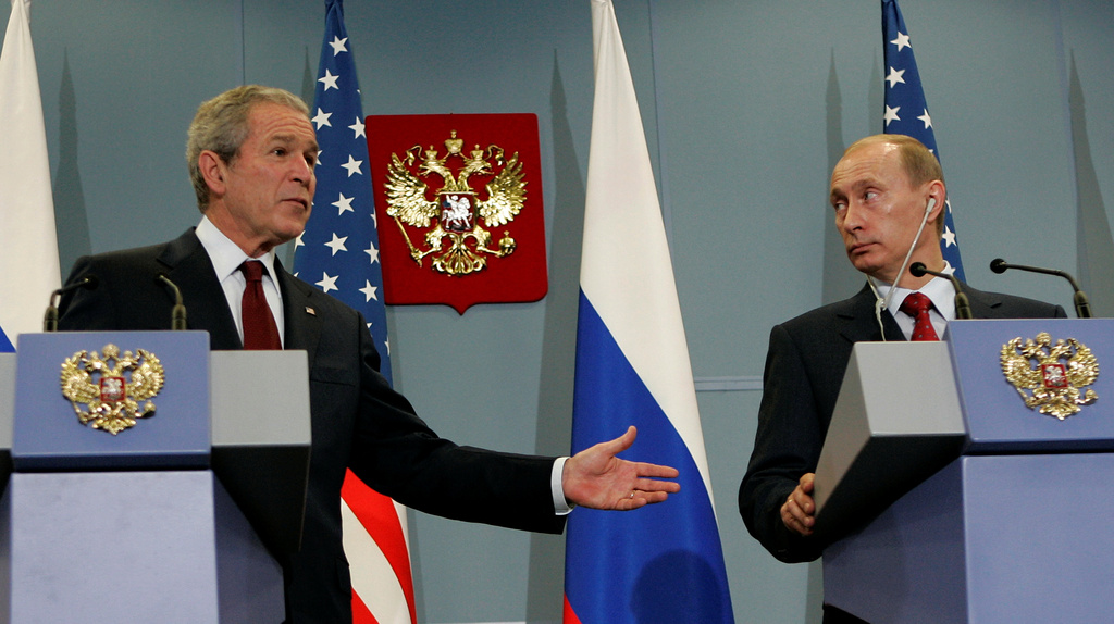 FILE- Russian President Vladimir Putin, right, and U.S. President George W. Bush look on during their news conference in the Black Sea resort city of Sochi, southern Russia, Sunday, April 6, 2008. (AP Photo/Alexander Zemlianichenko, File)