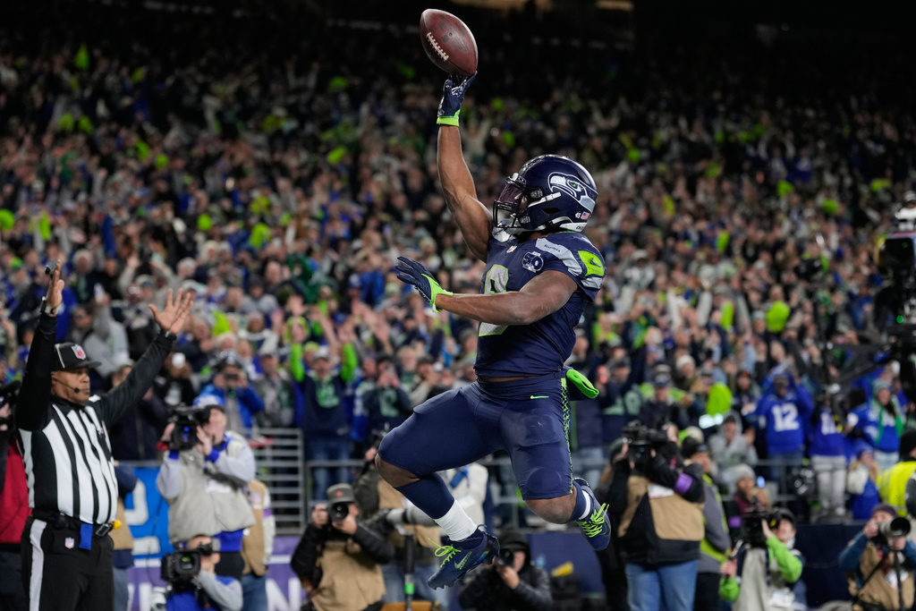 Seattle Seahawks running back Kenneth Walker III (9) celebrates after scoring a touchdown during the second half of an NFL football divisional playoff game against the San Francisco 49ers, Saturday, Jan. 17, 2026, in Seattle. (AP Photo/Stephen Brashear)