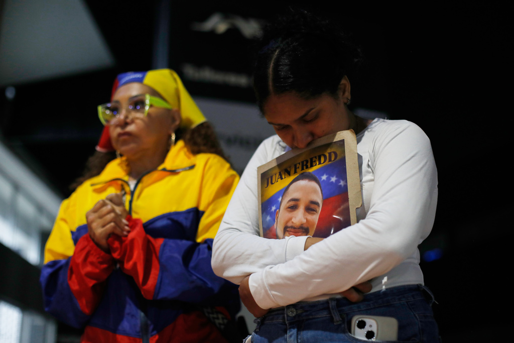Relatives of detainees they say are held for political reasons wait outside El Helicoide, headquarters of Venezuela's intelligence service and a detention center, after the National Assembly approved an amnesty bill in Caracas, Venezuela, Thursday, Feb. 19, 2026. (AP Photo/Crisitian Hernandez)