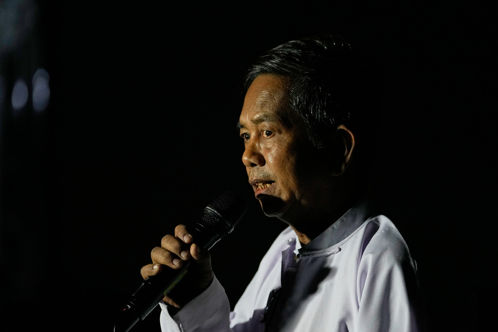 An official of the Union Election Commission announces the open of a polling station during the third phase of general election in Mandalay, central Myanmar, Sunday, Jan. 25, 2026. (AP Photo/Aung Shine Oo)