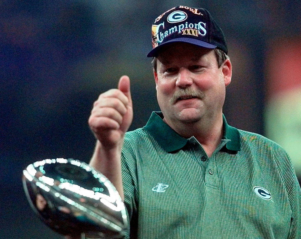 FILE - In this Jan. 26, 1997, file photo, Green Bay Packers coach Mike Holmgren gives a thumbs up behind the Lombardi Trophy after the Packers beat the New England Patriots 35-21 to win Super Bowl XXXI NFL football game in New Orleans. (AP Photo/Ed Reinke, File)